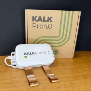 KalkPro 4.0 industri‑enhed – elektronisk kalkspalter med kobberbånd, som forebygger kalkaflejringer, foran emballage på træbord